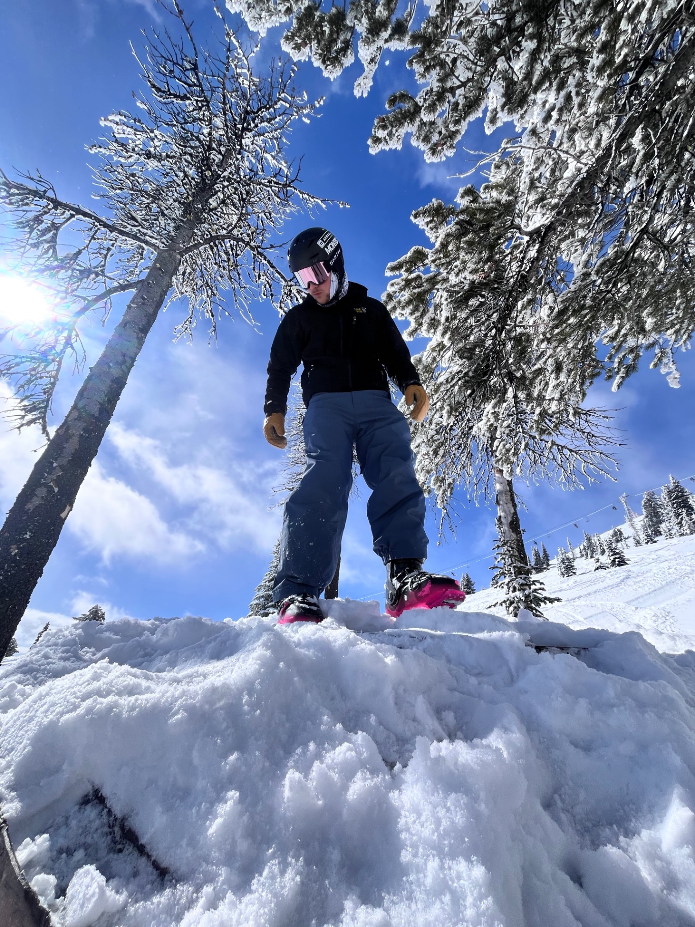 Mathieu Dionne en skis, bottes roses, au sommet d'une butte enneigée